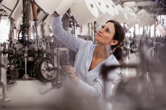 Woman Checking Cotton Reel In A Textile Factory