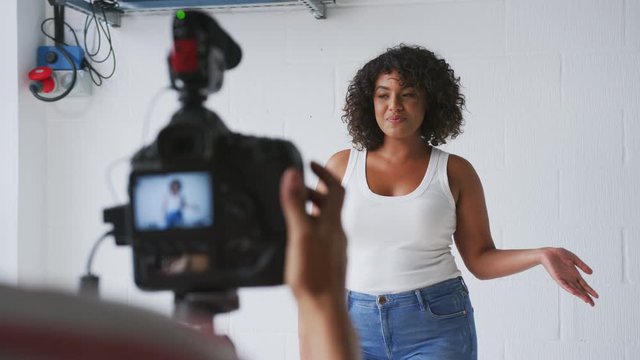Female Videographer Filming Woman Recording Podcast In Studio