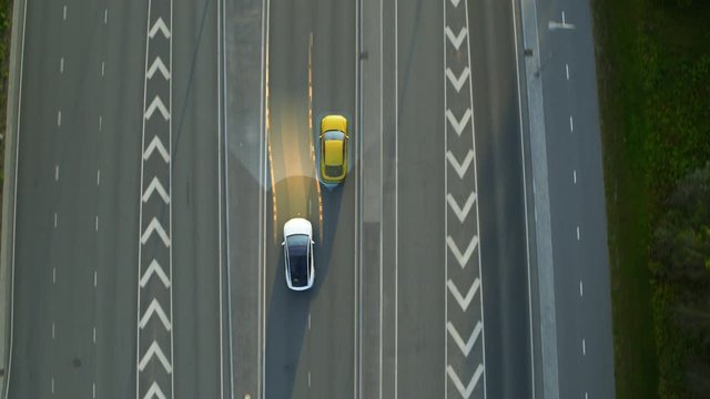 Aerial Top Down View: Autonomous Self Driving Car Moving Through City, Overtaking Other Vehicles. Animated Scanning Visualization Concept: Artificial Intelligence Digitalizes and Analyzes Road Ahead