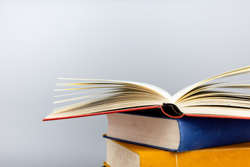 Stack of old books on gray background