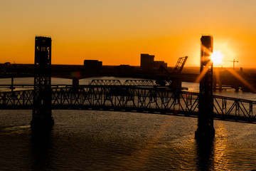 Fototapeta na wymiar The John T. Alsop, Jr. Bridge in Jacksonville FL at a beautiful golden sunset. The bridge was previously named the Main Street Bridge and is still called that today.