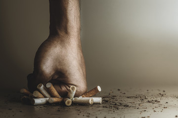 Hand fist smash or punch on cigarette.Cigarettes is addictive to be cancer.smoking reduction...