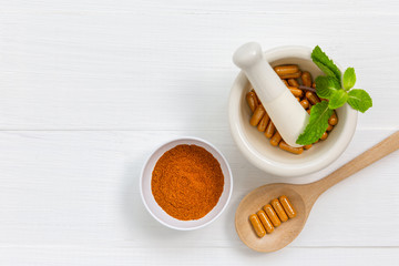 Herbal supplement in capsules with healthy medicinal plant.Alternative drug or natural pharmaceutical capsule.Medication of vitamin supplemental for care and treatment.Top view.