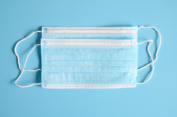 medical masks blue color to cover the mouth and nose for protection from bacteria on a blue...