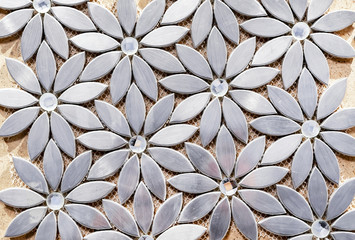 Metal mosaic tile in the form of flowers. Interior background from of silver flowers.