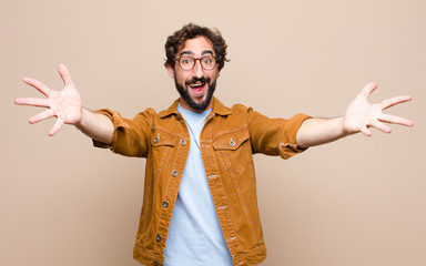 young cool and crazy man against flat wall