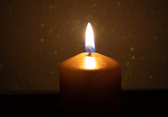 golden candle with golden sparkles