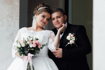 Newlyweds groom and bride. Wedding couple on their wedding day. Stylish luxury  plus size bride and...