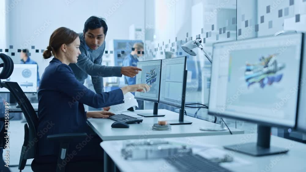 Aufkleber Inside Factory Office: Male Project Supervisor Talks to a Female Industrial Engineer who Works on Computer, Talk. In Workshop: Professional Workers Use High-Tech Industry 4 CNC Machinery, Robot Arm.