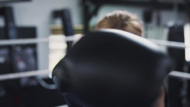 Point Of View Shot Of Female Boxing Coach In Gym Sparring In Boxing Ring