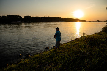 Fototapeta na wymiar Men fishing on the river