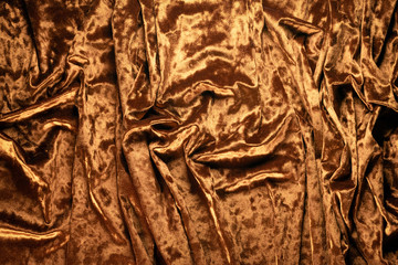 Golden velvet cloth texture background. Top view.