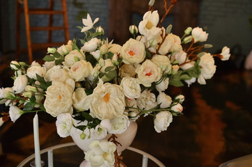 A large and lush bouquet of white flowers in a vase.