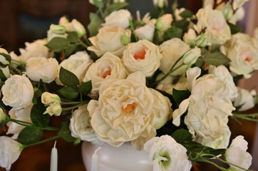 A large and lush bouquet of white flowers in a vase.
