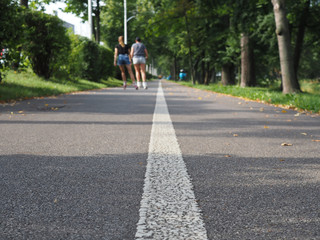 Rollerblading. Holidays, active people and friendship concept. Young girls on roller skates riding...