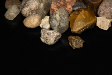 multicolored stones in close-up on a black background