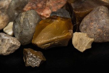 multicolored stones in close-up on a black background