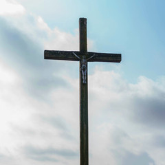 Jesus Christ cross. Easter, resurrection concept. Christian wooden cross on a background with dramatic sky.