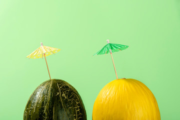 Two melons with cocktail umbrella, Summer melon drink concept