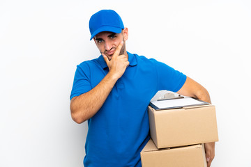 Fototapeta na wymiar Delivery man over isolated white background thinking an idea