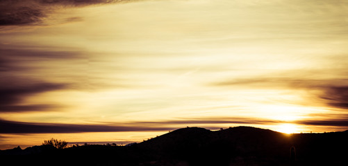Panoramic image of a sunset over the Sonoran Desert of Arizona.