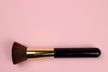 make up brush powder blusher on pink background