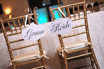 Bride and groom signs on the chairs