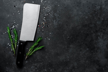  meat ax, kitchen knife with  spices on stone background, with copy space - obrazy, fototapety, plakaty