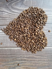 coffee beans in bowl on wooden background