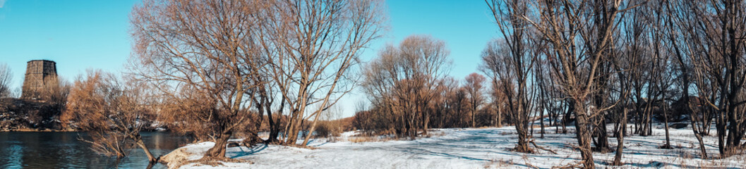 panorama of the winter snow landscape of the river and the river Bank