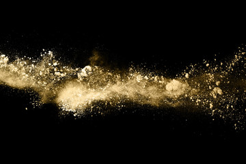 Fototapeta na wymiar Golden powder explosion on black background. Freeze motion.