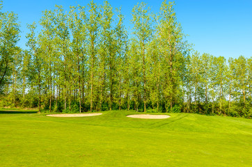 Golf course with gorgeous green and sand bunker