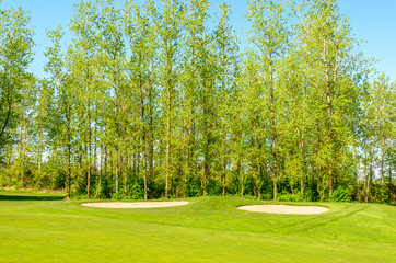 Golf course with gorgeous green and sand bunker