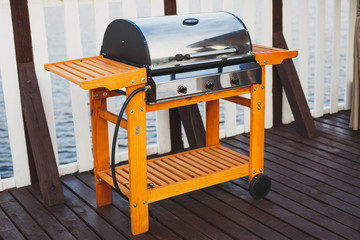 Grill on the terrace of the landing stage. Barbecue outdoors.