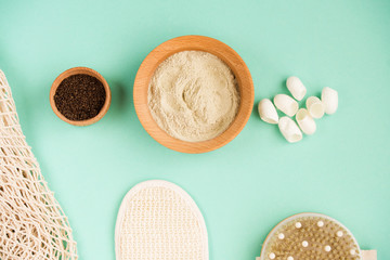 Cosmetic bath salt, grape gomaj for the face, coffee scrub for the body on a mint background. Spa cosmetic, zero waste.