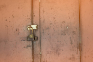 The old iron door has rusted. The padlock is locked. No key