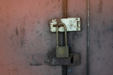 The old iron door has rusted. The padlock is locked. No key