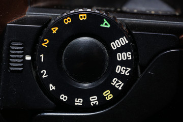 Setting wheel for ISO and aperture on an old camera photographed in the studio