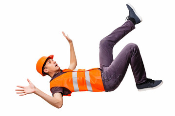 Leg and yellow helmet of injured lying worker at work.