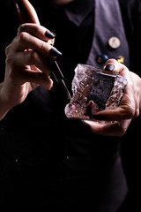 barman breaking ice with pick