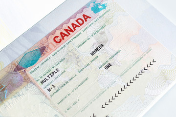 Canadian working visa in passport. Immigration to Canada concept.