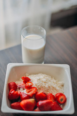Strawberries, glass of milk and cottage cheese