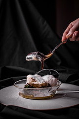 Person eating molten chocolate cake close up black background