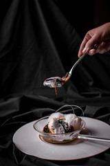 Person eating molten chocolate cake close up black background