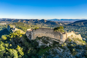 Aerial view of Xativa castle located near Valencia Spain on the ancient roadway  Via Augusta leading from Rome to Cartagena. Two forts connected by walls and curtains running down surrounding the city