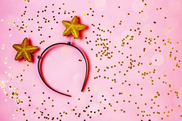 Pink festive background with sparkles and gifts, copy space, flat lay