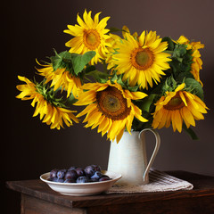 sunflowers and plums. bouquet of large yellow sunflowers © Masquerade