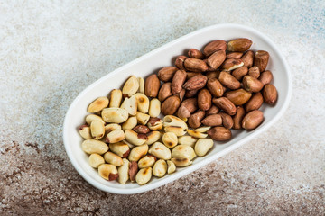 Peanuts in a white cup an old wooden floor. ramadan food. healthy nutrition. healthy food. vegetarian snack