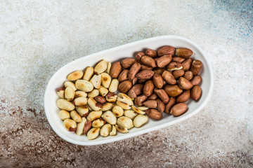Peanuts in a white cup an old wooden floor. ramadan food. healthy nutrition. healthy food. vegetarian snack