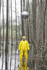 professional in protective uniform, mask, gloves with silver sphere drone above his head   in...